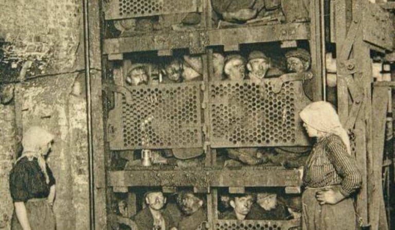 The Truth Behind The Haunting Photo Of A Crude Elevator Crammed With Miners