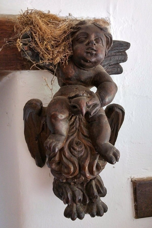 The wooden angel figures in the hallway, complete with straggly twigs