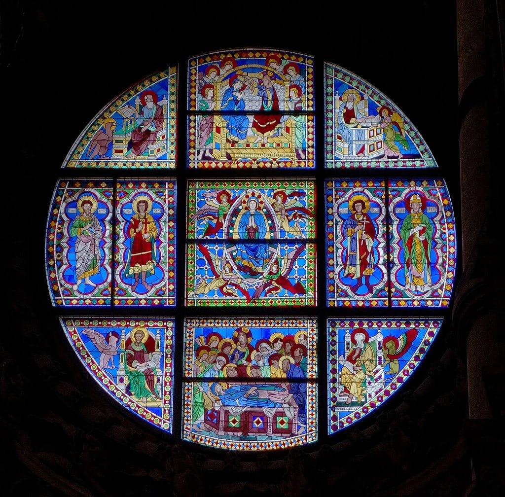 Stained-glass window above altar depicting the life of Mary