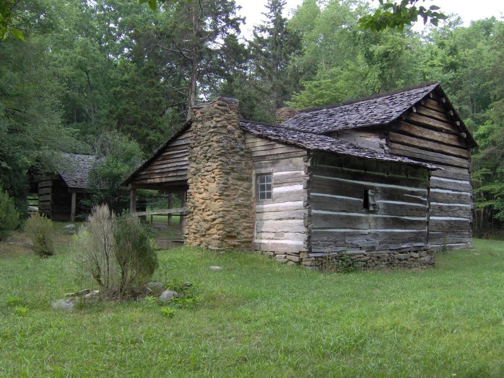 Walker Cabin, showing the older section and porch in the foreground, and the newer section rising behind it