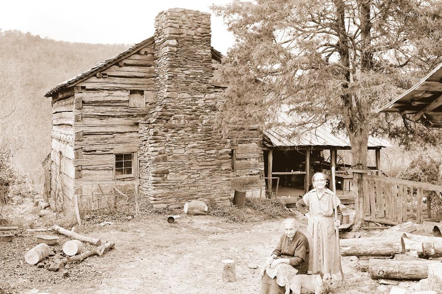 The surviving Walker Sisters: Margaret (age 91, standing) and her sister Louisa (age 79) in front of their big house — Walker Family Farm