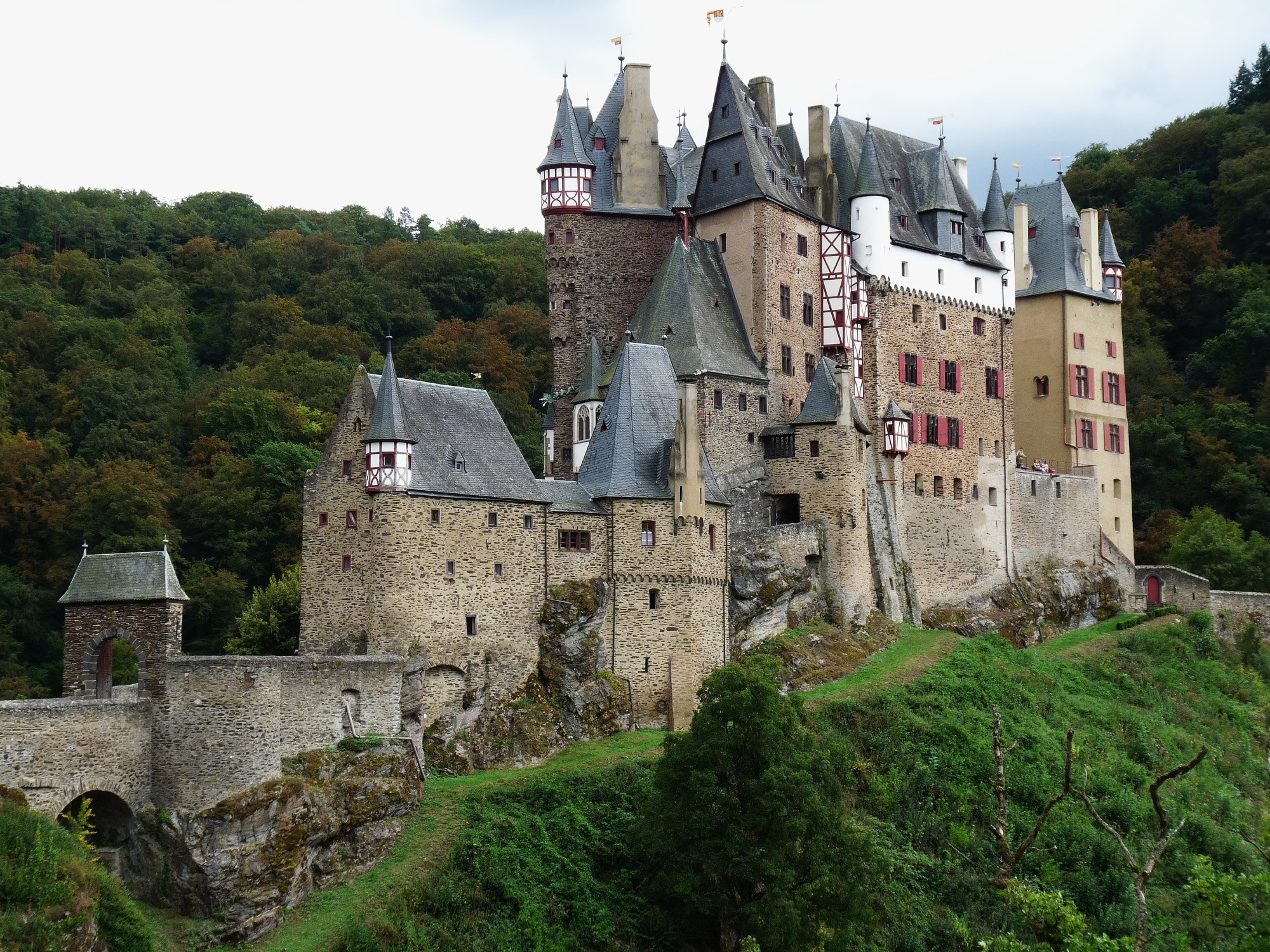 Eltz Castle along with the surrounding valley, as seen from the path leading up to the entrance.