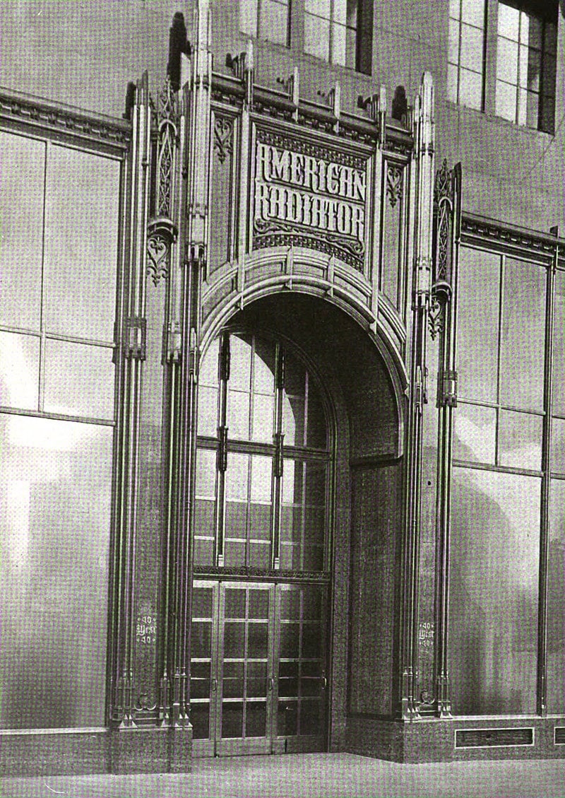 The American Radiator Building in Manhattan, New York, as depicted in American Architect and Architecture magazine, volume 126, Nov 1924 (published in Dec 1924). Original caption: "DETAIL OF MAIN ENTRANCE BUILDING FOR AMERICAN RADIATOR CO., WEST 40TH STREET, NEW YORK RAYMOND M. HOOD, ARCHITECT"