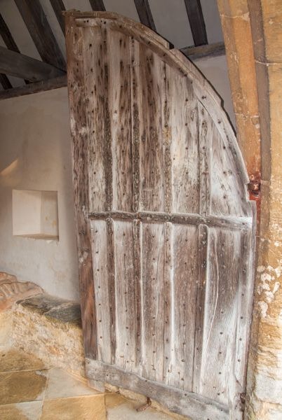 The worn medieval porch door