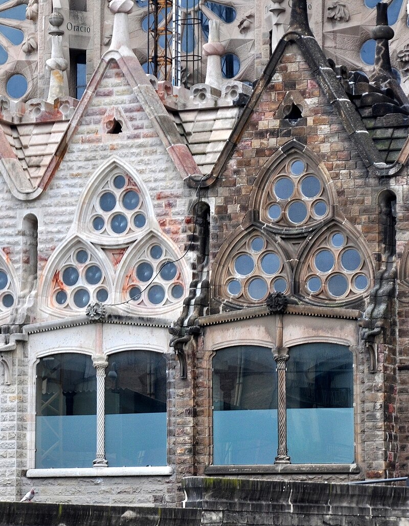 New stonework at Sagrada Família (left) is visible against the stained and weathered older sections (right)