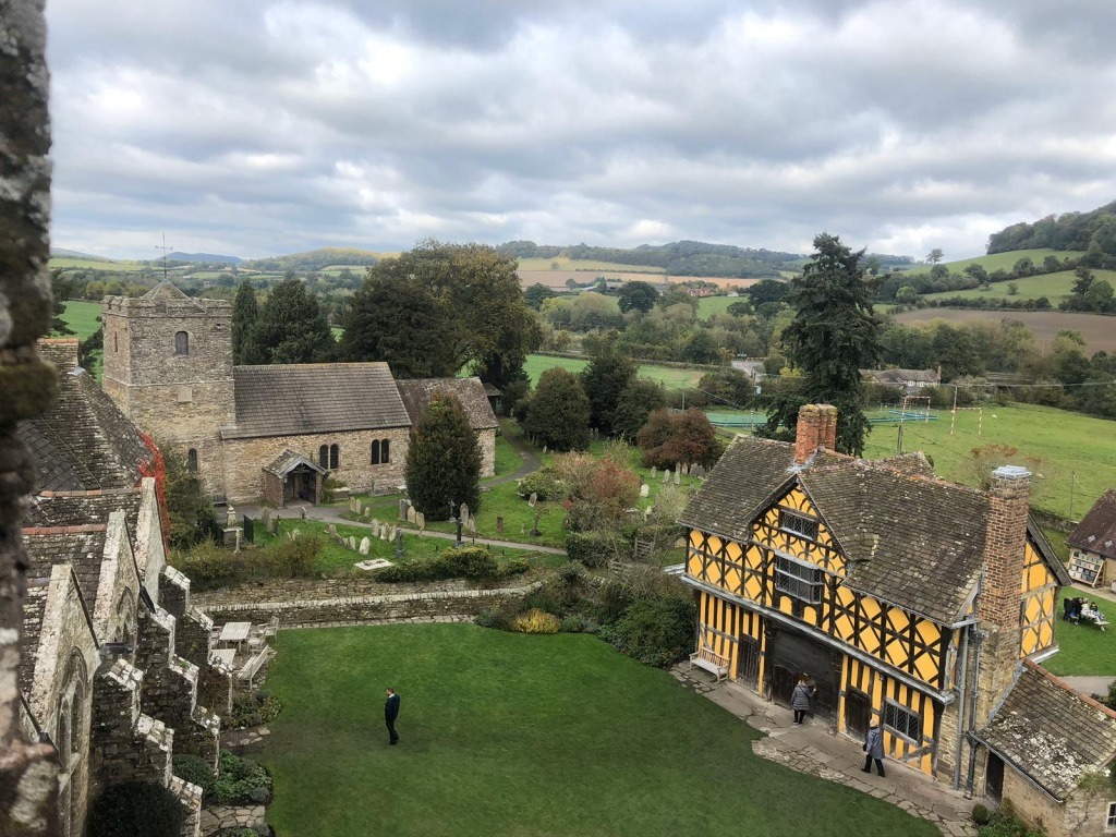 The courtyard, with the 13th-century south tower and solar block (l), the church (c) and the 17th-century wood and plaster gatehouse