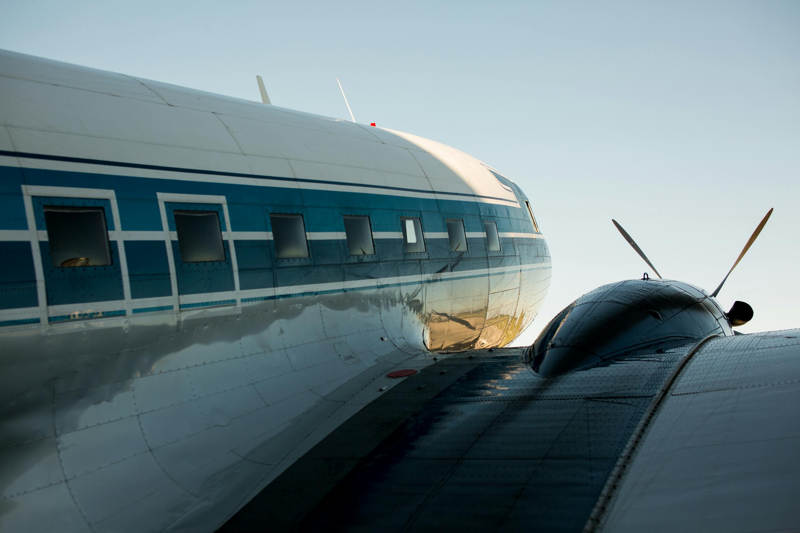 Close-up of vintage aircraft on the tarmac showcasing its detailed fuselage and propeller.